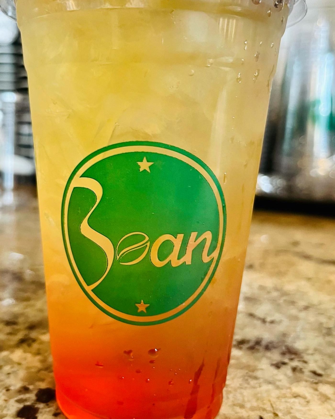 A gradient iced tea in a Bay Shore Bean cup on the counter